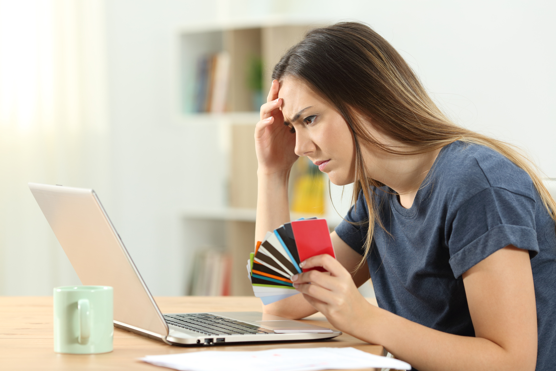 Worried shopper holding multiple credit cards